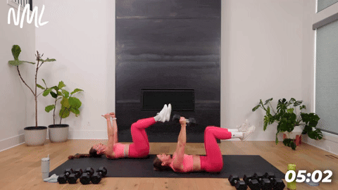 two women performing dead bugs in a full body workout