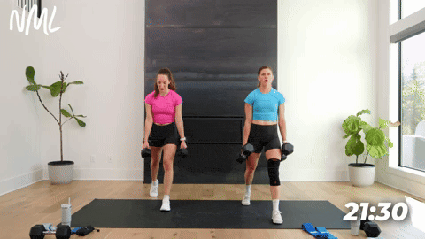 two women performing dumbbell split lunges in a leg workout