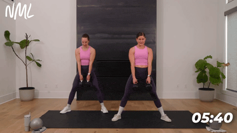 two women performing sumo deadlifts with dumbbells in an inner thigh workout at home