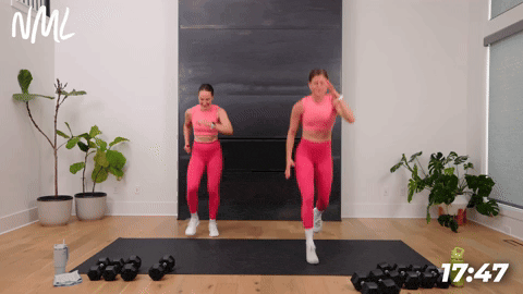 two women performing lunge jumps in a full body conditioning workout