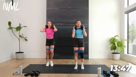 two women performing lateral squat walks in a leg workout