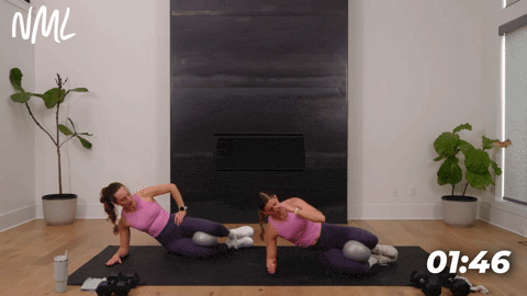two women performing a reverse clamshell with a pilates ball as part of the best exercises for the inner thighs