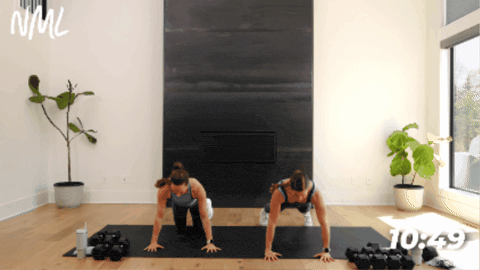 women performing a push up and open to side plank as part of dumbbell arm workout
