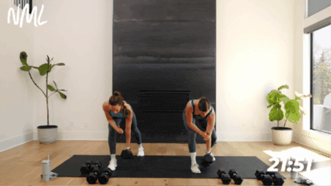 two women performing single arm back rows as part of arm workout with dumbbells