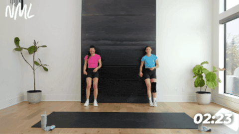 women performing a standing figure 4 as part of active recovery