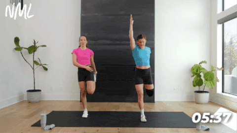 women performing a standing quad stretch