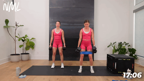 two women demonstrating how to perform dumbbell squats in a glute workout at home