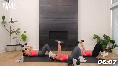 three women demonstrating how to do dumbbell skull crushers in a full body circuit workout