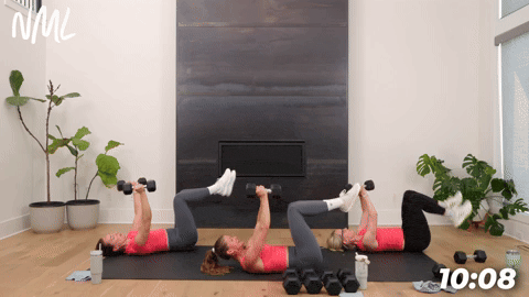three women demonstrating how to do chest fly knee tucks in a full body circuit workout