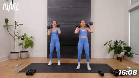 two women performing alternating dumbbell shoulder presses in a 20 minute workout at home