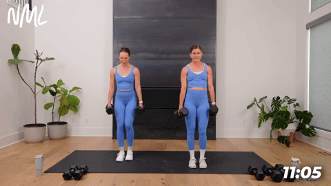 two women performing dumbbell split lunges in a 20 minute workout at home