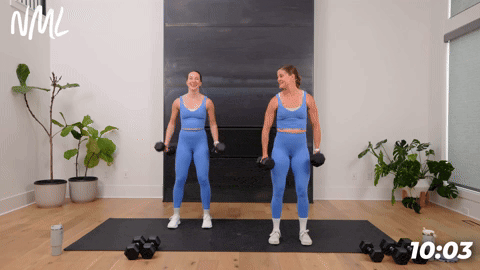 two women performing dumbbell bicep curls in a 20 minute workout at home