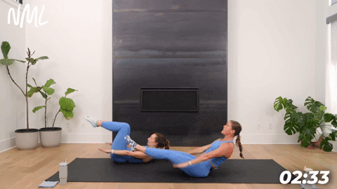 two women demonstrating how to do pilates hundreds from the mat in a pilates workout