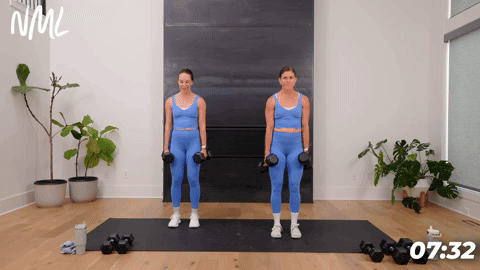 two women performing calf raises in a 20 minute home workout