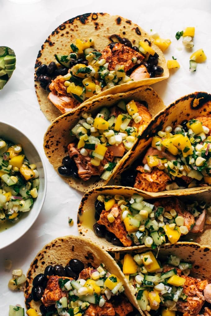 Easy salmon tacos with salmon, corn, cucumbers, black beans, flour wraps. 