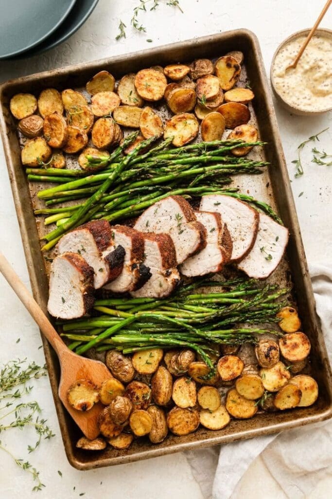 Sheet Pan Pork Tenderloin with roasted potatoes, asparagus and homemade creamy sauce.  