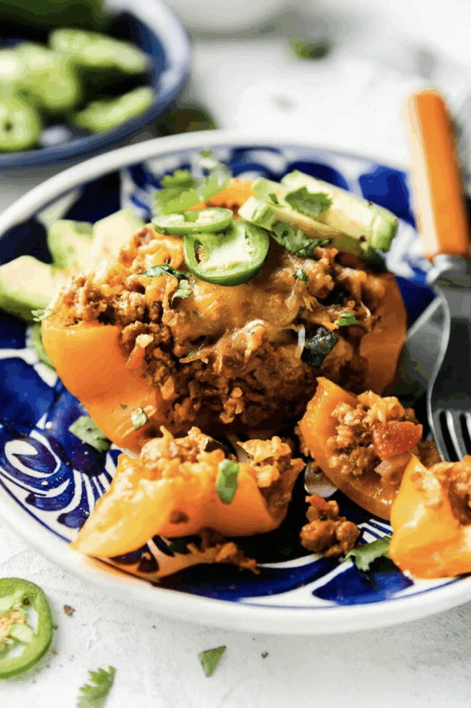 Stuffed orange peppers with ground beef, veggies, cheese 