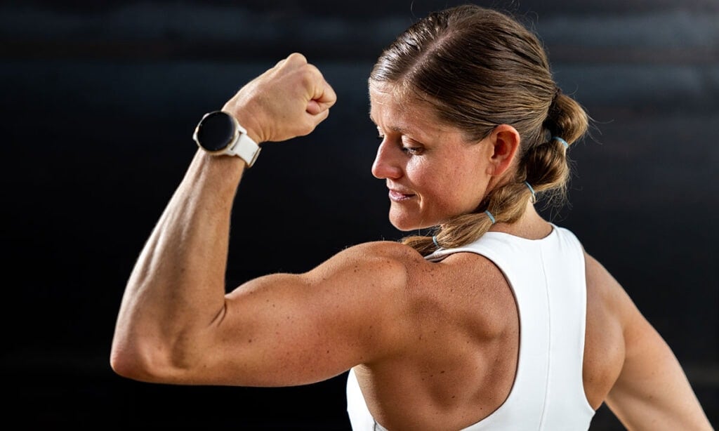 woman flexing bicep as part of self-improvement winter arc challenge