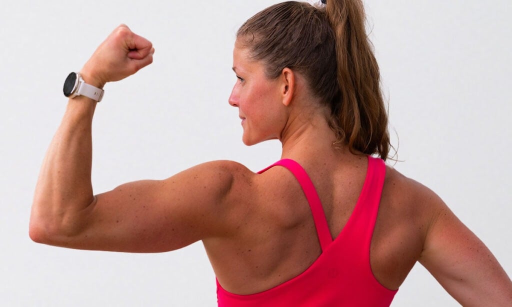 woman flexing bicep after completing arm exercise with weights