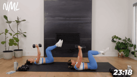 women performing a chest fly with a kickout to target abs as part of at home hiit workout