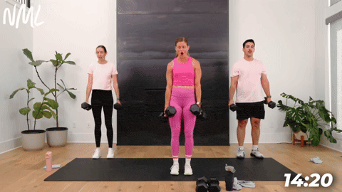 three people performing a side step squat in a full body dumbbell workout