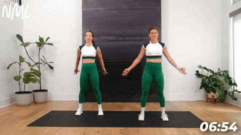 two women demonstrating bodyweight squats as part of leg stretches before a workout