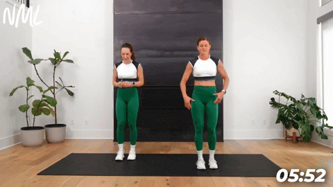 two women demonstrating bodyweight step back lunges as part of leg stretches before a workout