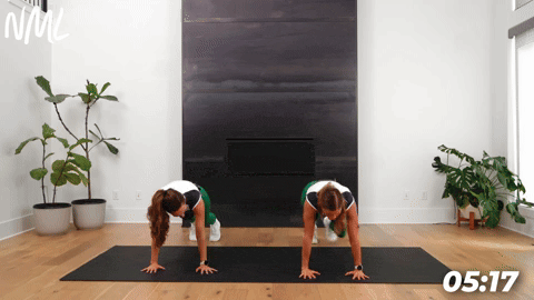 two women demonstrating spiderman step ins as part of leg stretches before a workout