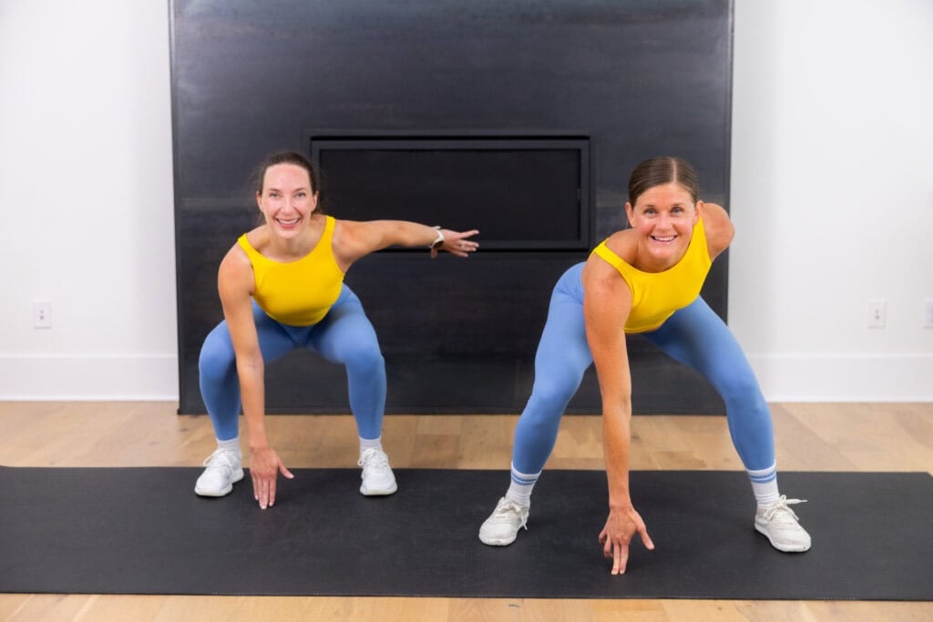 two women demonstrating squat jumps in a bodyweight cardio workout