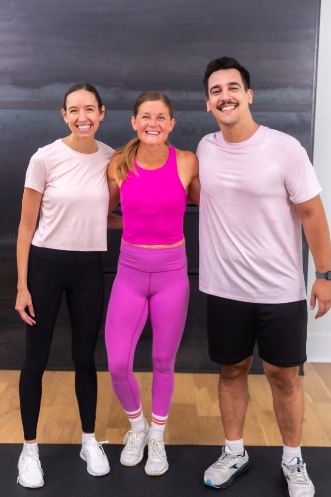 three people posing after completing a full body dumbbell workout together