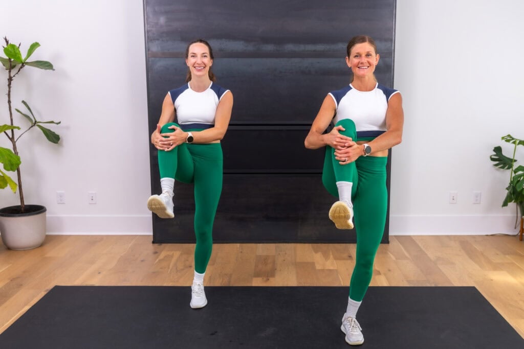 two women performing a knee hug as part of the best leg stretches before a workout