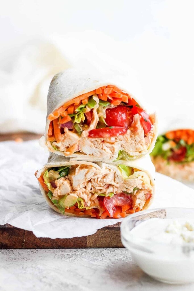 Buffalo Chicken Wrap with shredded chicken, tomatoes, carrots, lettuce and onions.