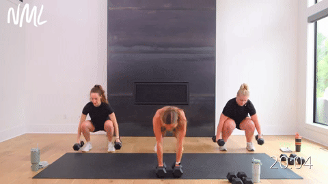 Two women performing squat, clean to an alternating shoulder press. One women performing burpee into an alternating shoulder press.