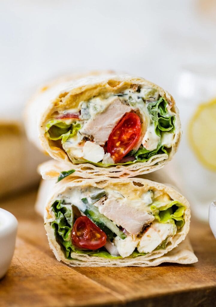 Greek Chicken Wrap with grilled chicken, homemade sauce, tomatoes, and cheese.