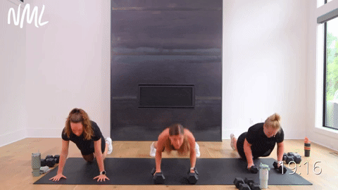Three women performing push up into two cross body crunches.