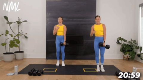 two women performing a lateral lunge with one dumbbell as part of cardio strength workout