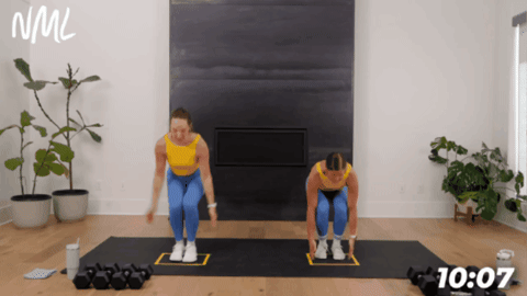 women performing a narrow squat jack a part of cardio strength exercise demonstration