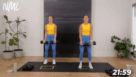two women demonstrating a wide bicep curl with lateral raises as part of cardio strength workout