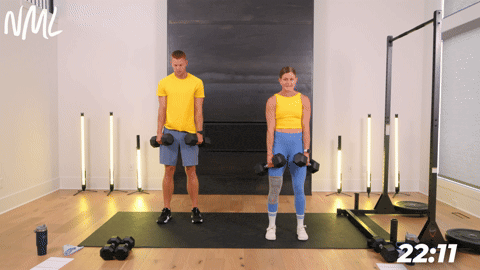 two people performing a dumbbell deadlift in an athletic back and leg workout