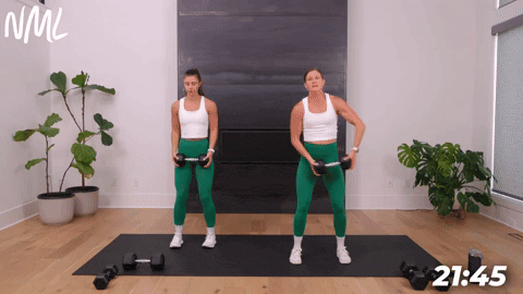 two women performing a dumbbell halo in a dumbbell core workout