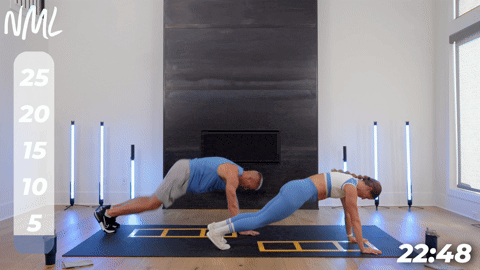 two people performing high plank knee tuck jumps in a cardio and core workout