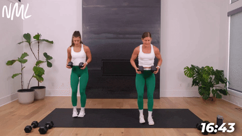 two women performing a reverse lunge and rotation in a dumbbell core workout