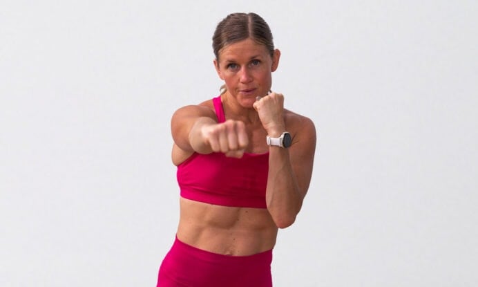 woman performing standing punches as part of 5 minute workout
