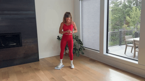 woman demonstrating lateral lunge slides as part of the best adductor exercises