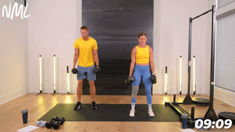 two people performing a dumbbell squat in an athletic back and leg workout