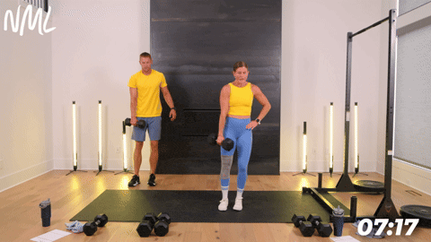 two people performing a dumbbell lateral lunge in an athletic back and leg workout
