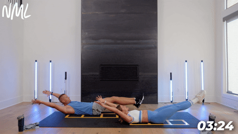 two people demonstrating a hollow rock hold to single sided bicycle crunch in a cardio and core workout