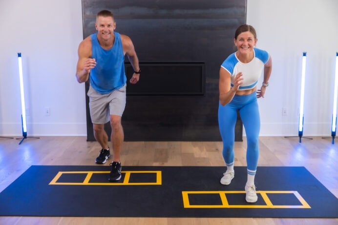 two people performing in and out runs in a cardio and core workout