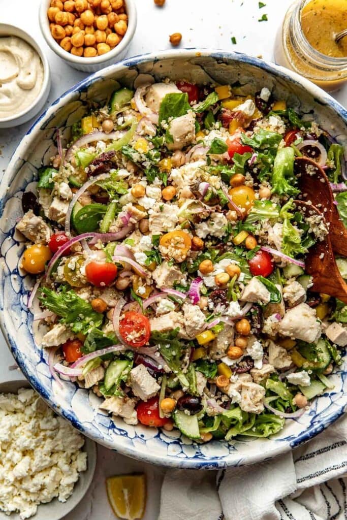 Chopped Mediterranean Salad With Chicken with veggies, chicken, quinoa and dressing.