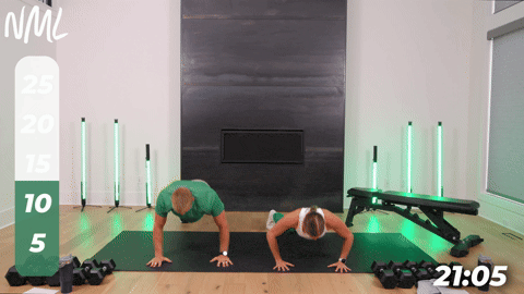 Male and female performing a push up and shoulder tap as part of a chest shoulder tricep workout. 